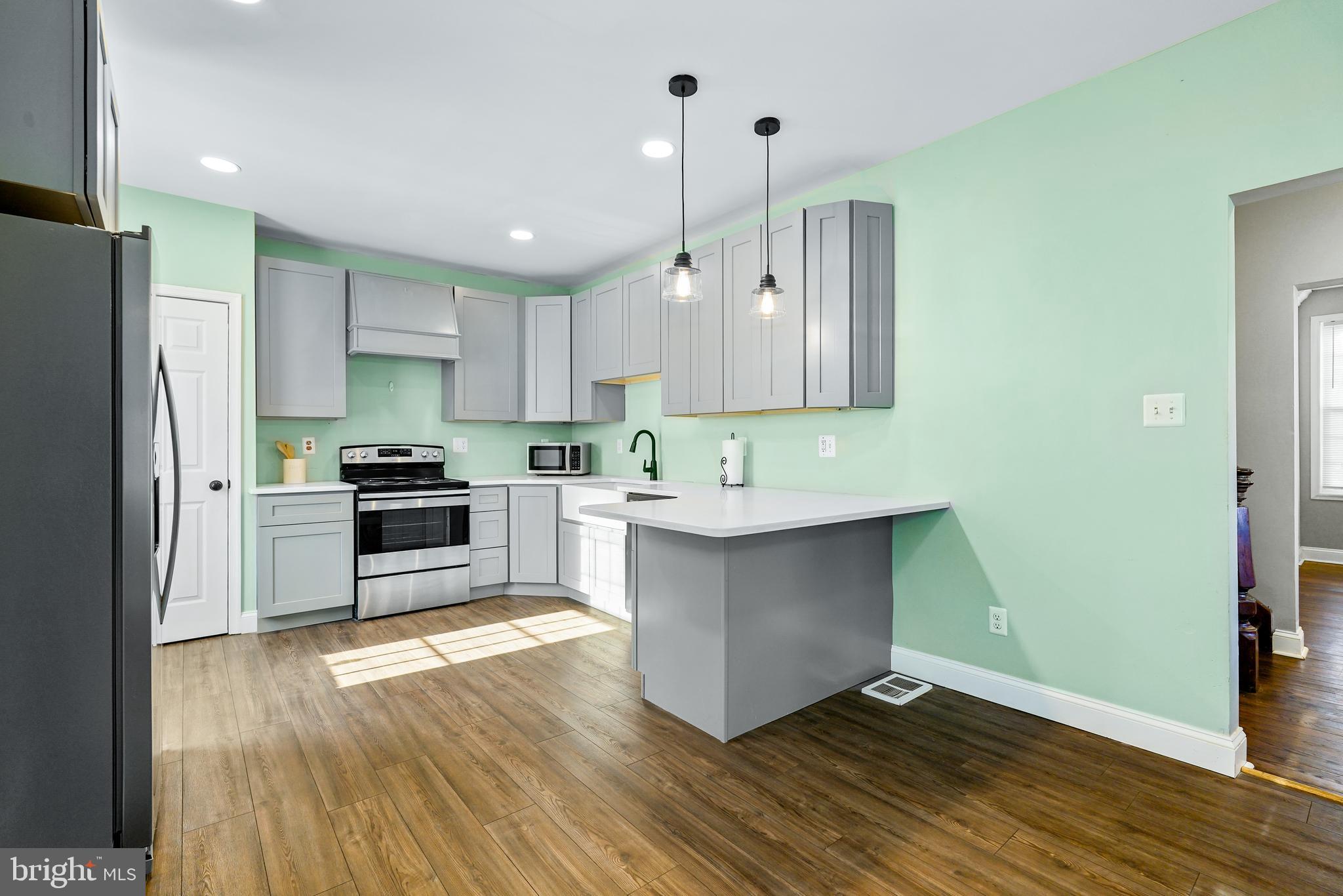 132 South Queen Street Rising Sun, MD 21911 - Photo 9 of 29 a kitchen with a refrigerator and a stove top oven
