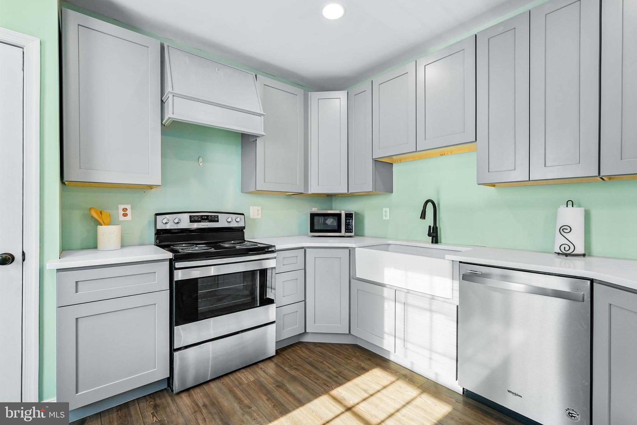 132 South Queen Street Rising Sun, MD 21911 - Photo 10 of 29 a kitchen with white cabinets and white appliances