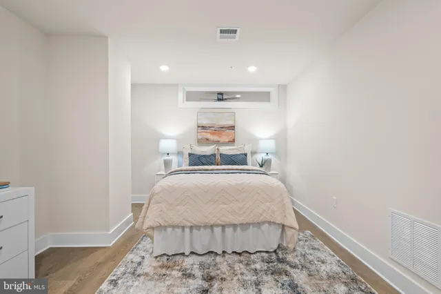 a bedroom with a bed and a night stand