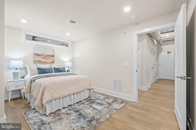 a bed room with a bed and a large window