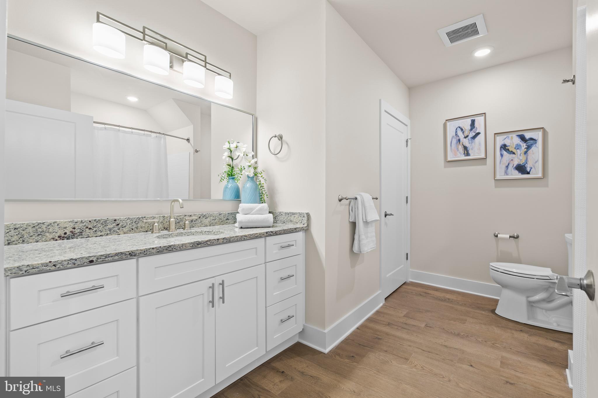 30 West Broad Street Souderton, PA 18964 - Photo 19 of 38 a spacious bathroom with a granite countertop sink a toilet and a mirror