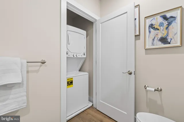 a spacious bathroom with a granite countertop sink a toilet and a mirror