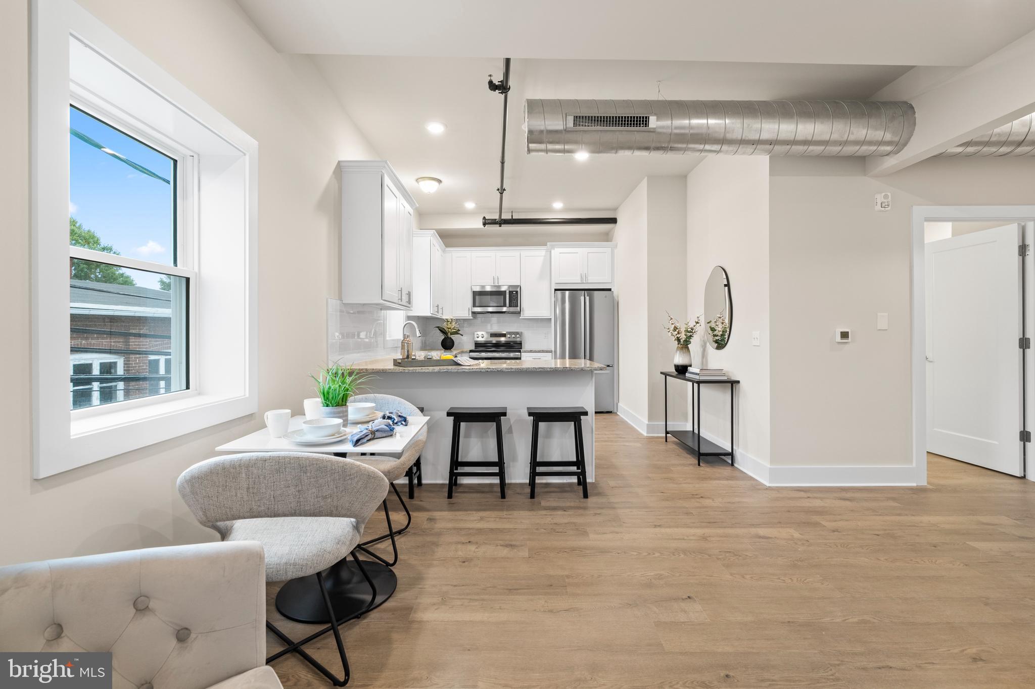 30 West Broad Street Souderton, PA 18964 - Photo 35 of 38 a kitchen with stainless steel appliances kitchen island granite countertop a refrigerator and a dining table