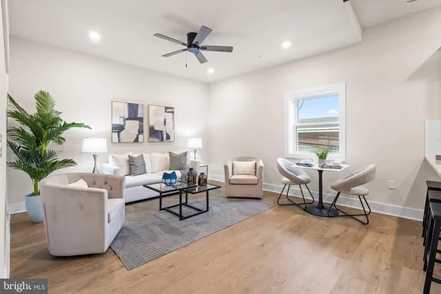 a kitchen with stainless steel appliances kitchen island granite countertop a refrigerator and a dining table