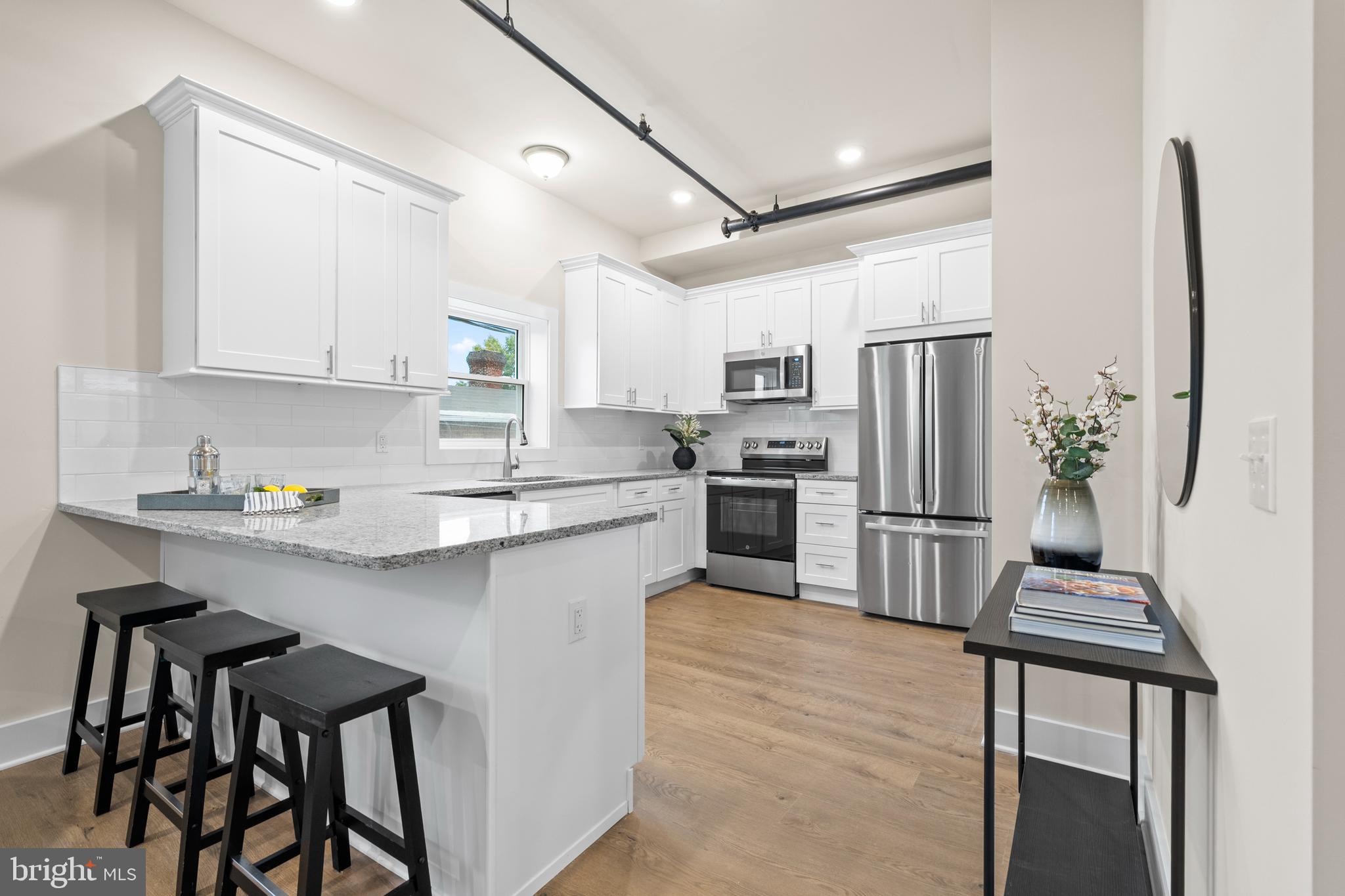 30 West Broad Street Souderton, PA 18964 - Photo 7 of 38 a kitchen with stainless steel appliances a refrigerator a stove a sink and chairs