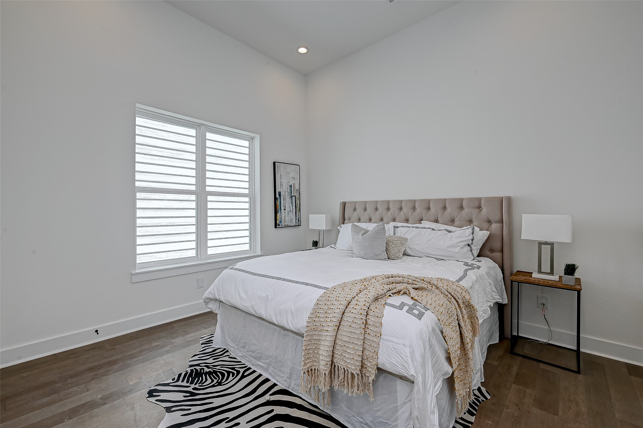 6129 West Montgomery Road Houston, TX 77091 - Photo 1 of 17 The spacious primary bedroom features soaring ceilings, hardwood floors, and abundant natural light filtered through designer window treatments the perfect retreat.