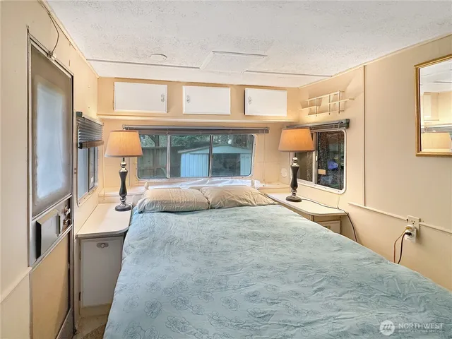 a large bedroom with a large bed and a large window