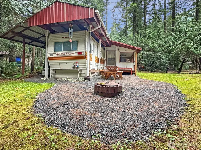 a view of a house with backyard porch and sitting area