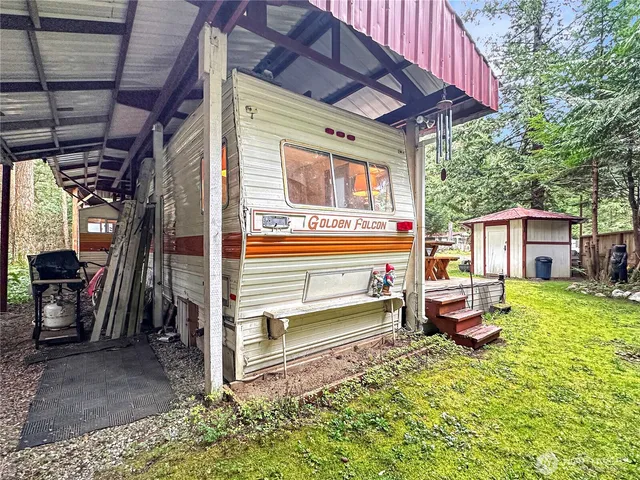 a front view of a house with a garden view
