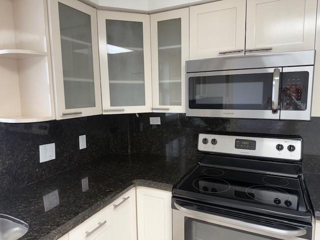 3500 Galt Ocean Drive, Unit 1408 Fort Lauderdale, FL 33308 - Photo 3 of 24 a kitchen with granite countertop a stove and a microwave