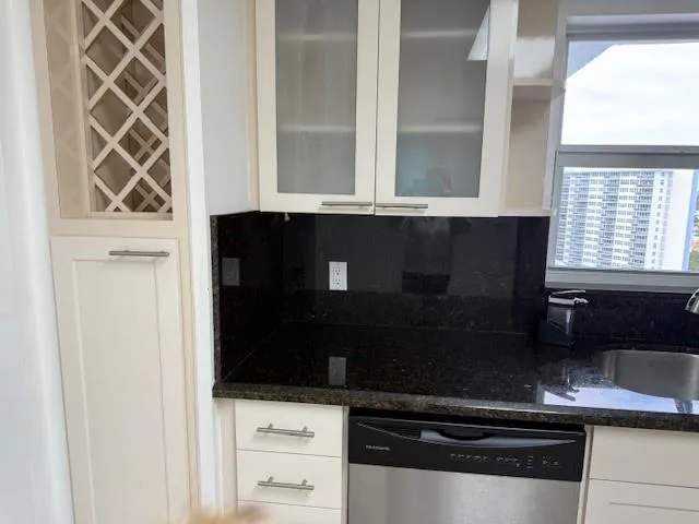 a kitchen with a sink and a mirror