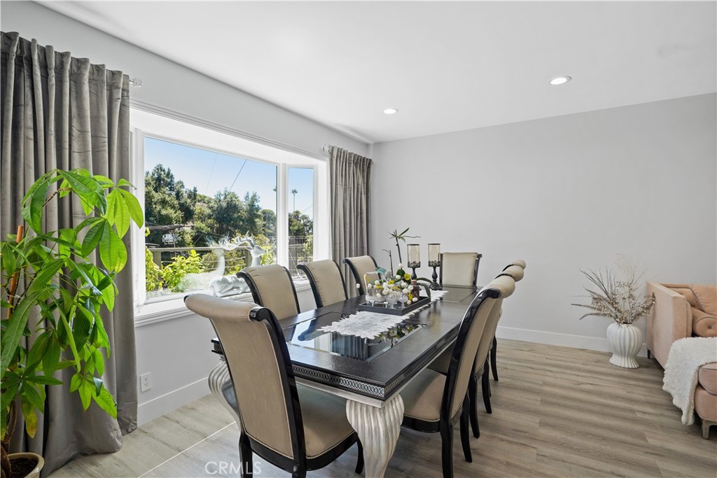 536 Cavanagh Road Glendale, CA 91207 - Photo 20 of 39 a dining room with furniture potted plants and wooden floor