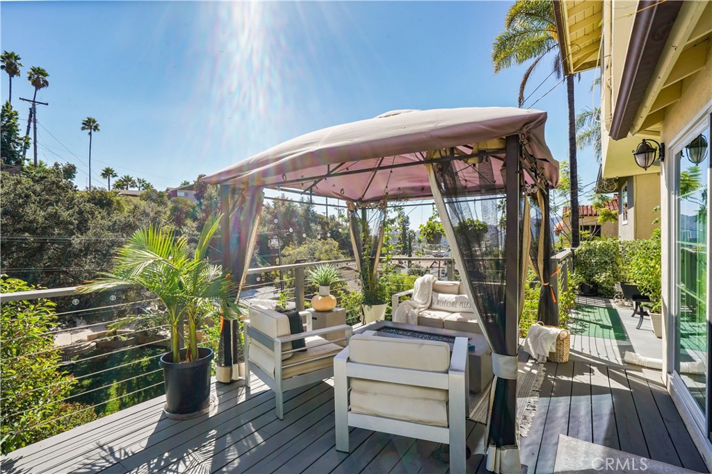 536 Cavanagh Road Glendale, CA 91207 - Photo 31 of 39 a view of a patio with table and chairs potted plants with wooden floor