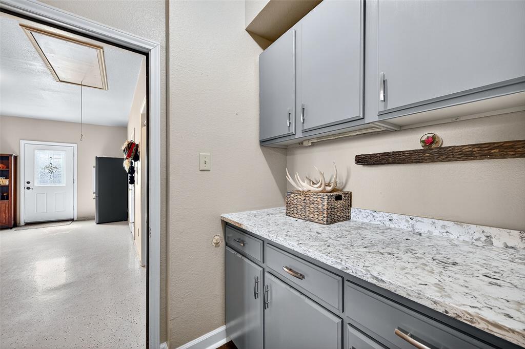 551 Massey Road Gunter, TX 75058 - Photo 12 of 40 a kitchen with granite countertop white cabinets and a sink