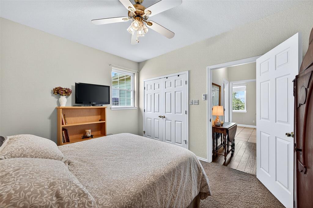 551 Massey Road Gunter, TX 75058 - Photo 15 of 40 a bedroom with a bed and a flat screen tv