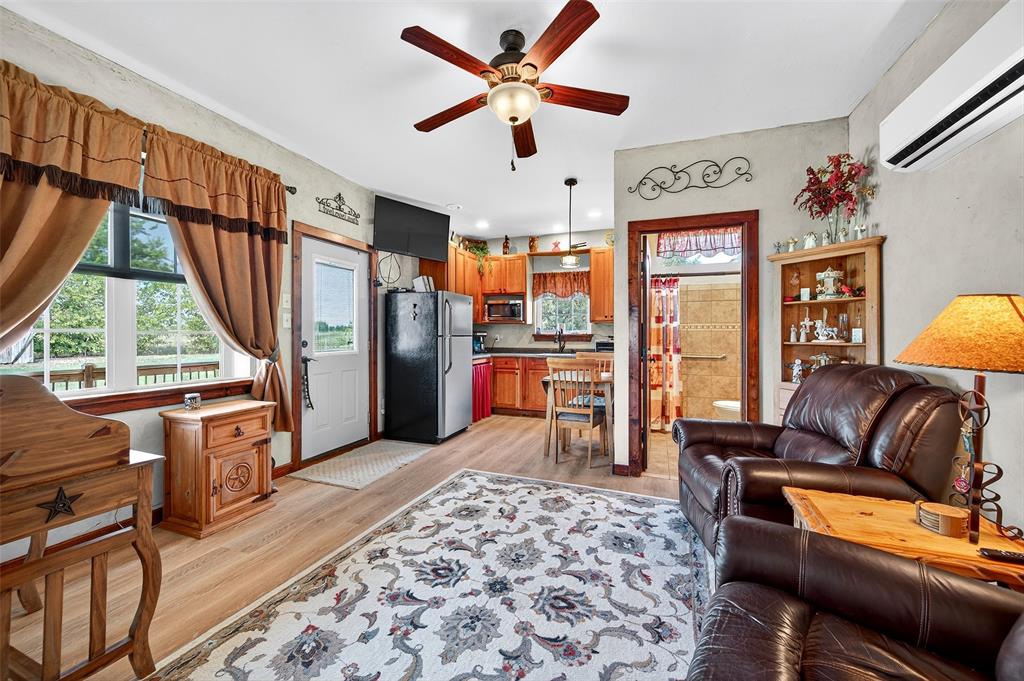 551 Massey Road Gunter, TX 75058 - Photo 21 of 40 a living room with furniture a window and a flat screen tv