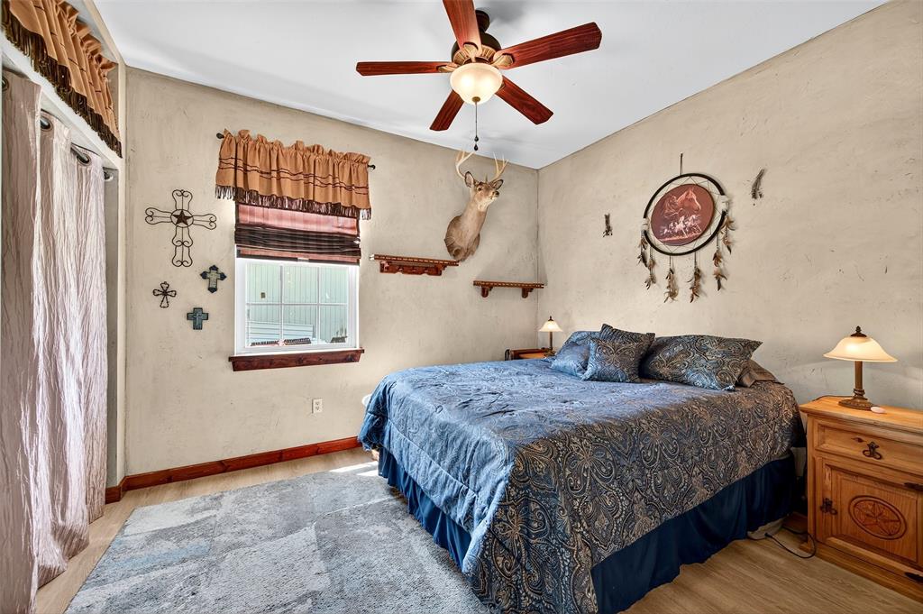 551 Massey Road Gunter, TX 75058 - Photo 24 of 40 a bedroom with a bed and a chandelier