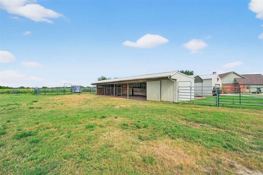 551 Massey Road Gunter, TX 75058 - Photo 25 of 40 a view of a backyard with table and chairs