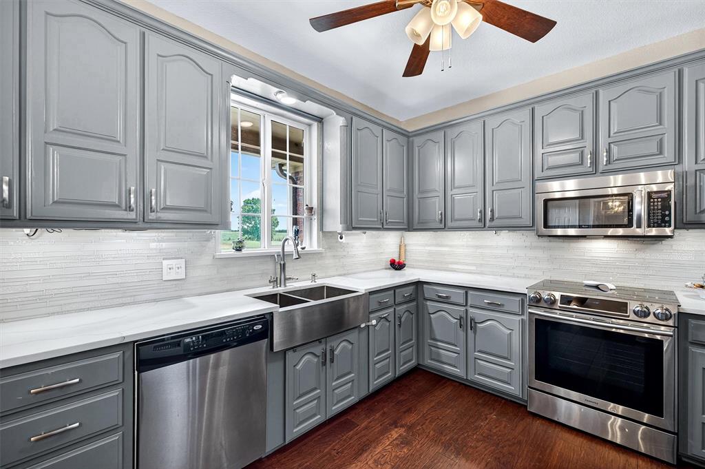 551 Massey Road Gunter, TX 75058 - Photo 9 of 40 a kitchen with stainless steel appliances granite countertop a sink and stove top oven