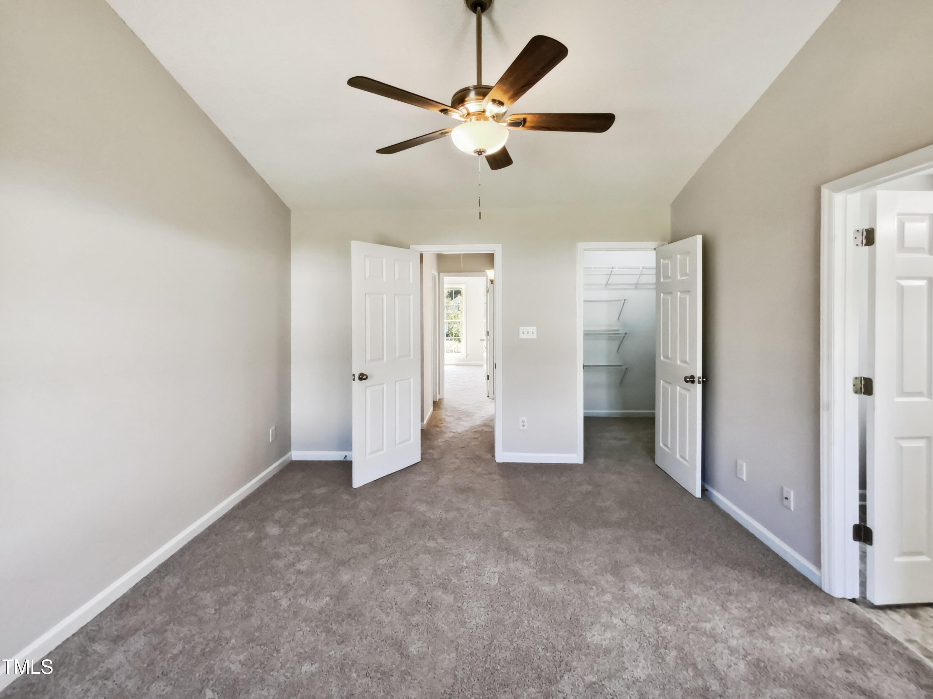 2221 Lockwood Folly Lane Raleigh, NC 27610 - Photo 11 of 19 a view of an empty room with a ceiling fan
