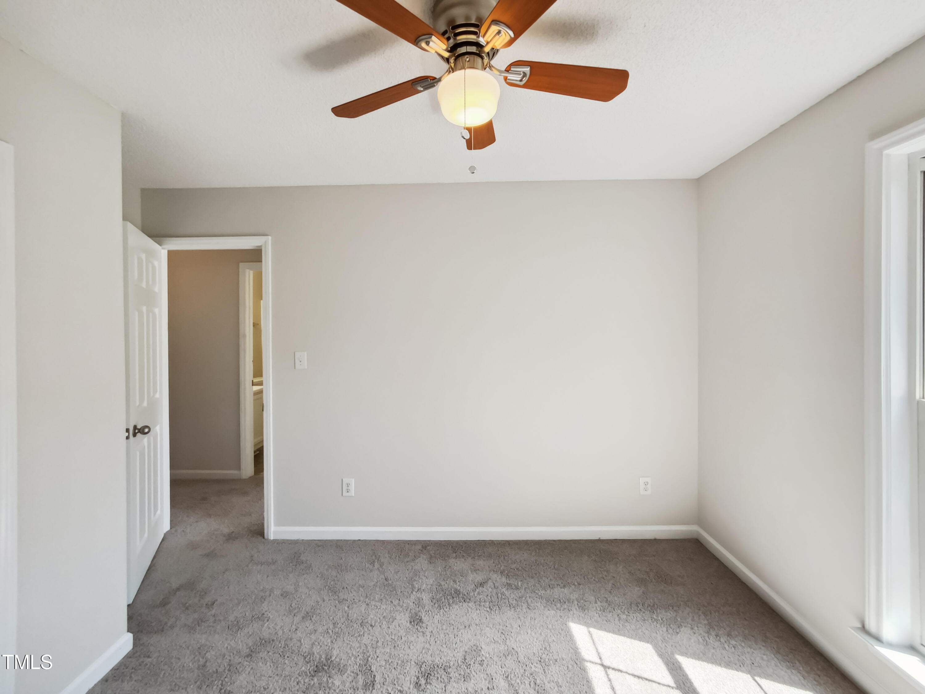 2221 Lockwood Folly Lane Raleigh, NC 27610 - Photo 14 of 19 an empty room with closet and a chandelier fan
