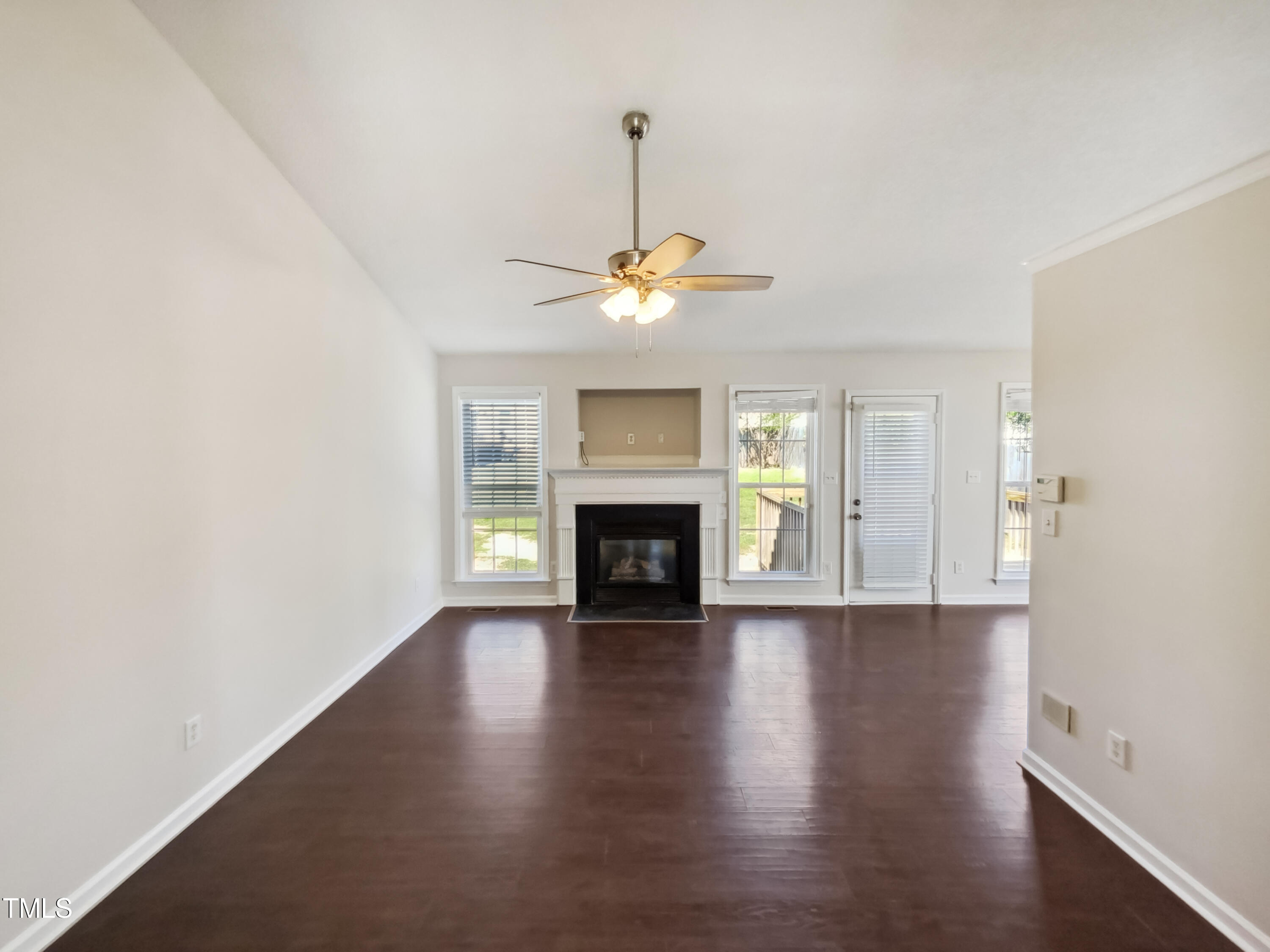 2221 Lockwood Folly Lane Raleigh, NC 27610 - Photo 3 of 19 a view of a livingroom with wooden floor a fireplace and windows