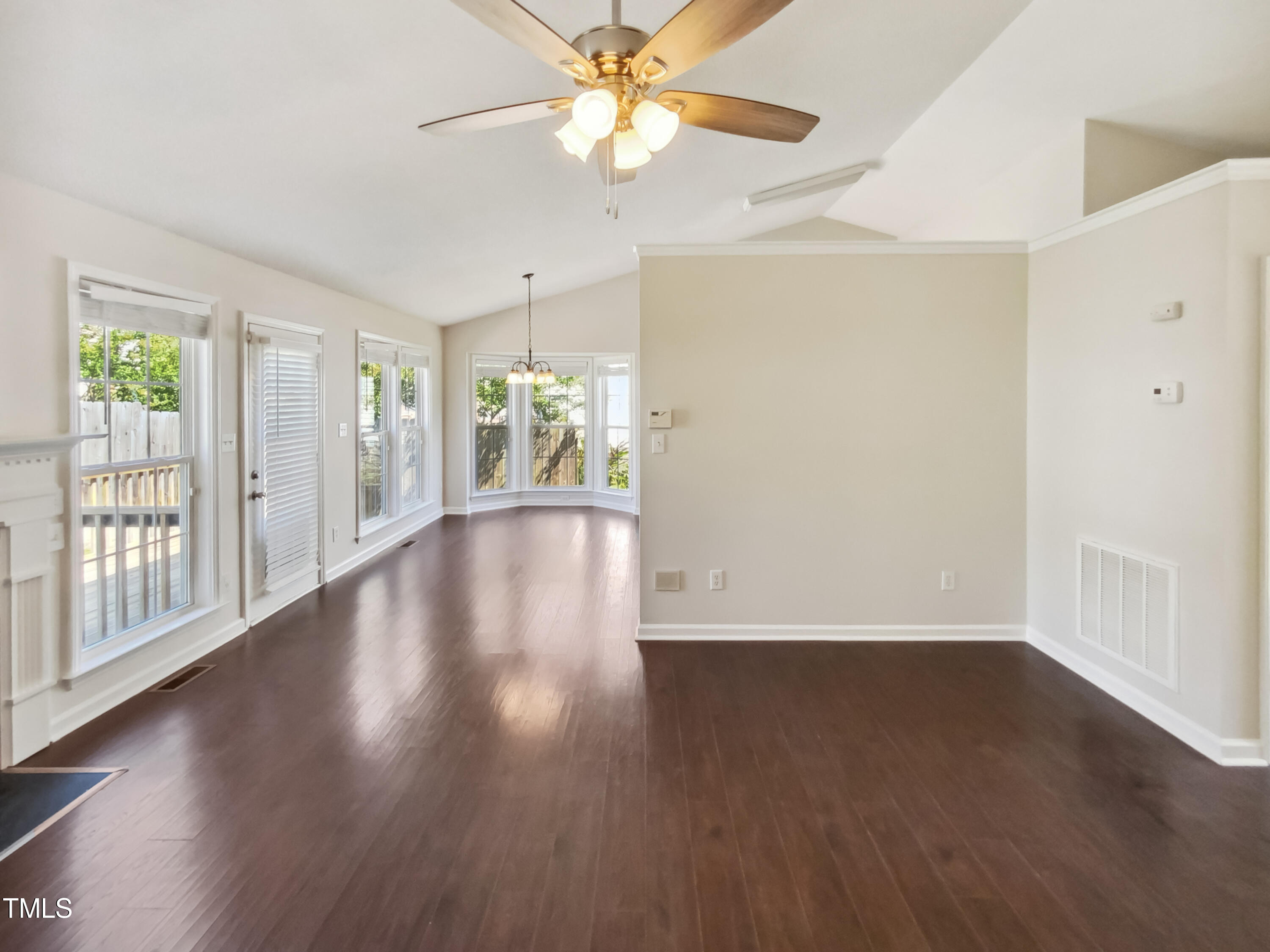 2221 Lockwood Folly Lane Raleigh, NC 27610 - Photo 8 of 19 a view of an empty room with wooden floor and a window