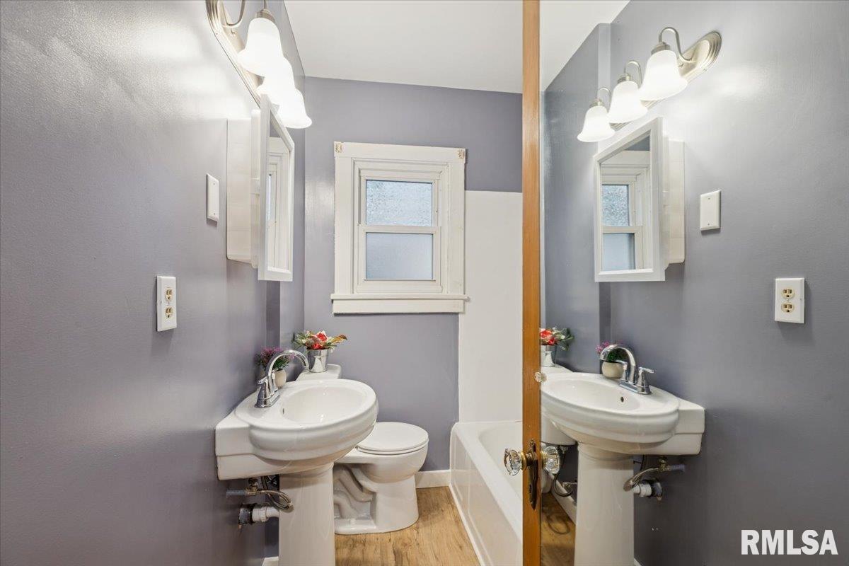 1820 33rd Street Moline, IL 61265 - Photo 12 of 25 a bathroom with a sink and a mirror