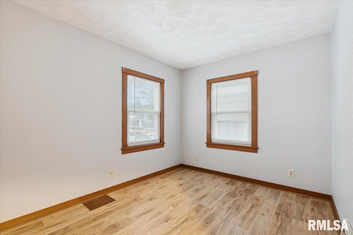 1820 33rd Street Moline, IL 61265 - Photo 14 of 25 an empty room with wooden floor and windows