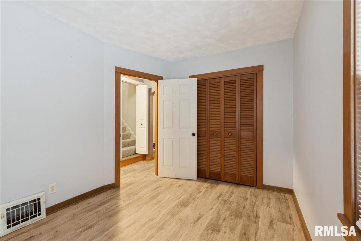 1820 33rd Street Moline, IL 61265 - Photo 15 of 25 an empty room with wooden floor and closet
