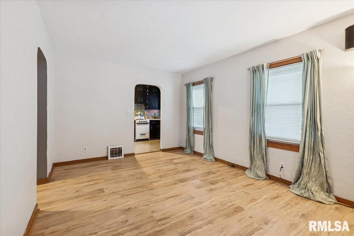 1820 33rd Street Moline, IL 61265 - Photo 4 of 25 a view of empty room with wooden floor and cabinet