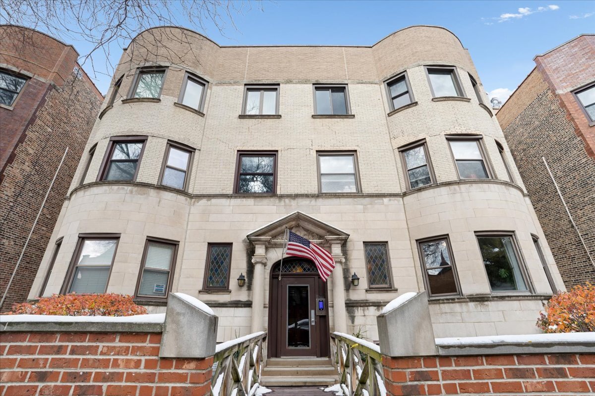 a view of a brick house with large windows