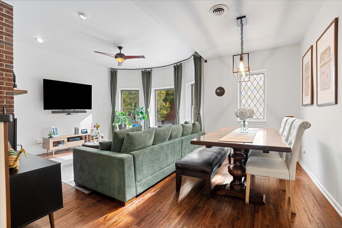 Undisclosed Address Chicago, IL 60613 - Photo 2 of 19 a living room with furniture a flat screen tv and a large window