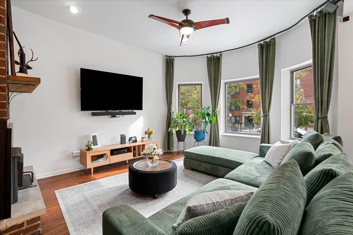 Undisclosed Address Chicago, IL 60613 - Photo 3 of 19 a living room with furniture a flat screen tv and a large window