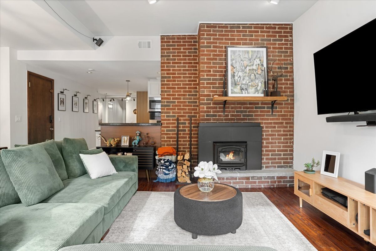 Undisclosed Address Chicago, IL 60613 - Photo 6 of 19 a living room with furniture a flat screen tv and a fireplace