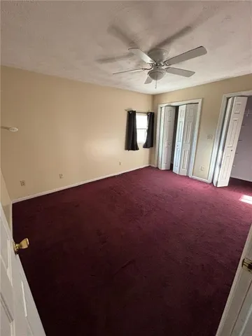 an empty room with windows and entrance