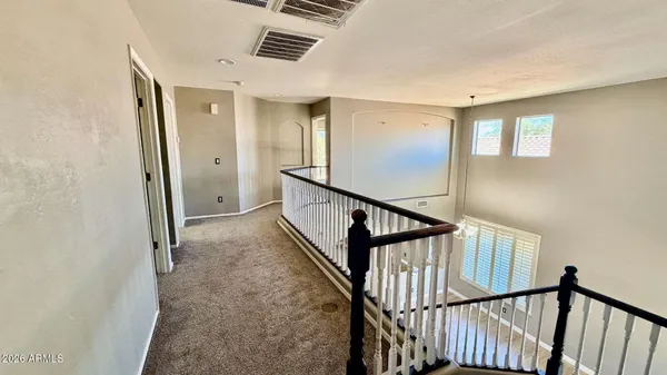 a view of staircase with wooden floor and fan