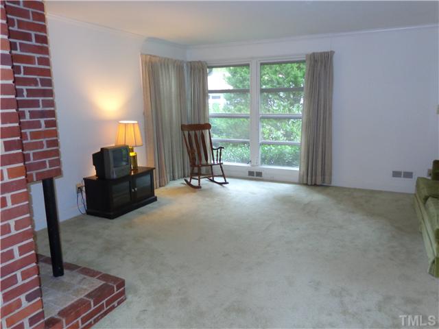 800 Daniels Street Raleigh, NC 27605 - Photo 2 of 23 Spacious living room with masonry fireplace and gas logs.