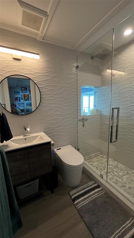 1041 Hillsboro Mile, Unit 3 Hillsboro Beach, FL 33062 - Photo 19 of 22 a bathroom with a toilet sink and mirror