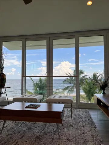 a room with pool table and windows