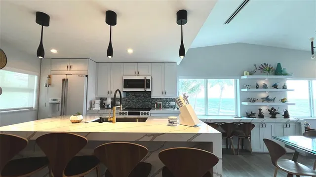 a kitchen with a table chairs sink and cabinets