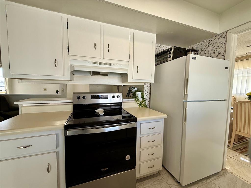 13508 Santa Rosa Avenue Port Charlotte, FL 33981 - Photo 12 of 30 a kitchen with cabinets appliances and cabinets