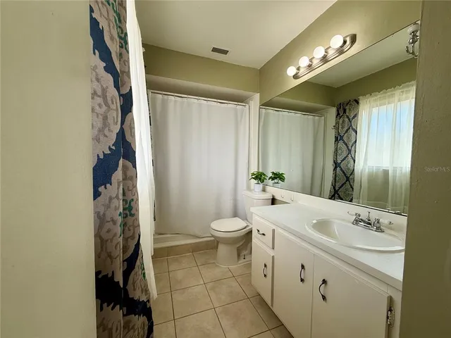 a living room with furniture and a lamp