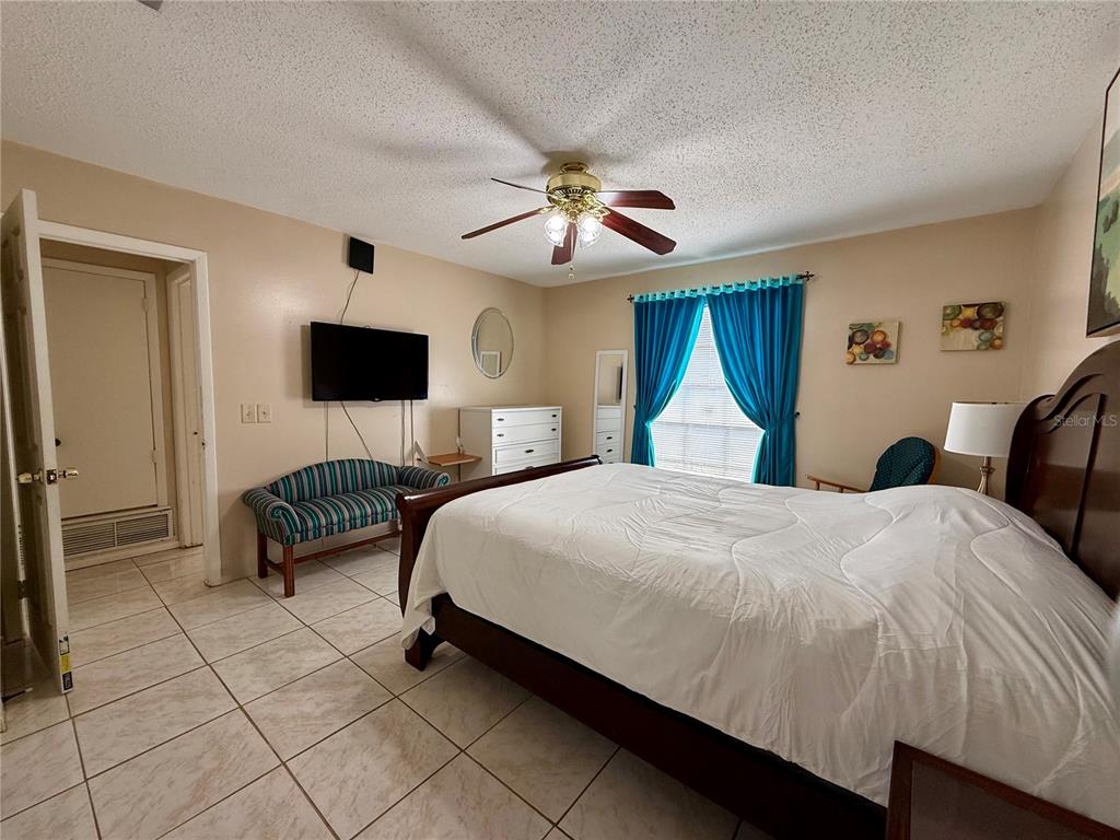 13508 Santa Rosa Avenue Port Charlotte, FL 33981 - Photo 21 of 30 a bedroom with a bed and a chandelier