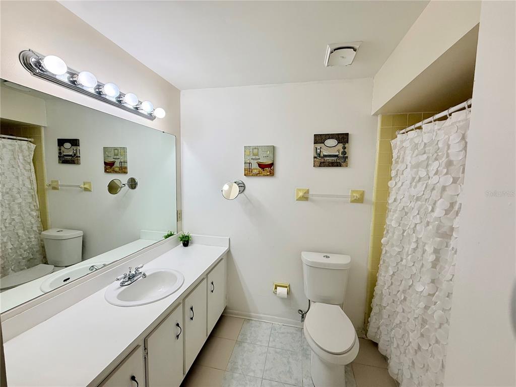 13508 Santa Rosa Avenue Port Charlotte, FL 33981 - Photo 23 of 30 a spacious bathroom with a toilet sink and mirror