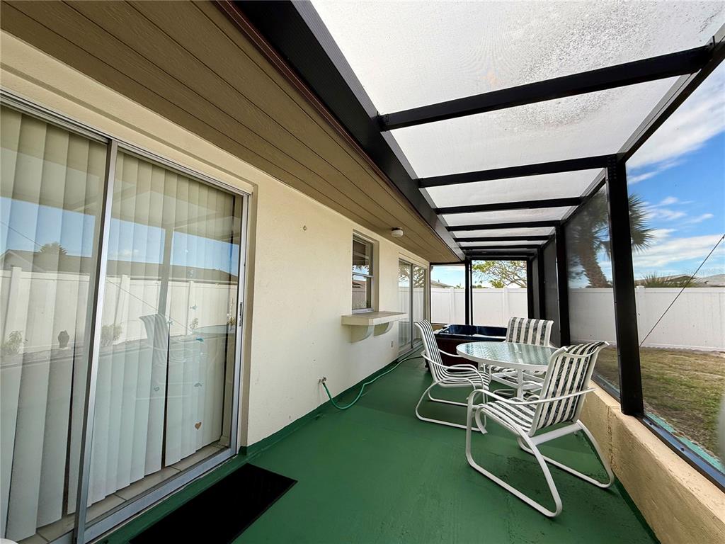 13508 Santa Rosa Avenue Port Charlotte, FL 33981 - Photo 27 of 30 a balcony with chairs and a table