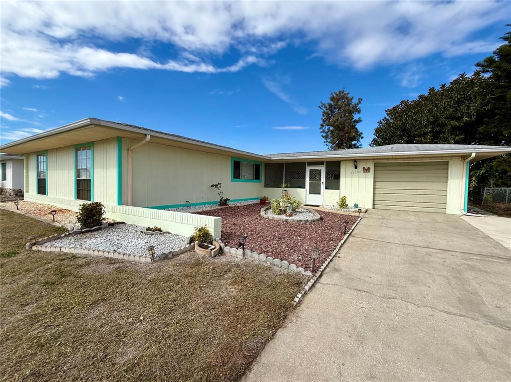 13508 Santa Rosa Avenue Port Charlotte, FL 33981 - Photo 28 of 30 a front view of a house with a yard