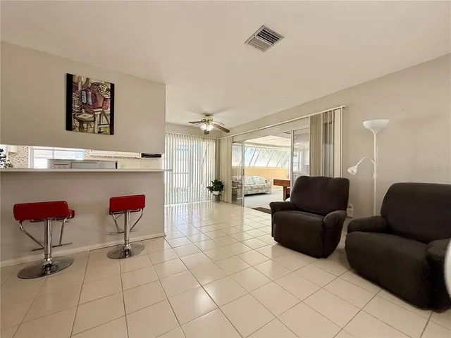 a reading room with furniture and a potted plant