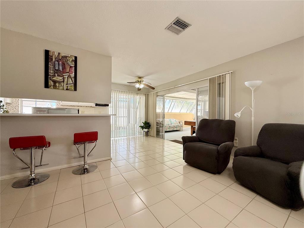 13508 Santa Rosa Avenue Port Charlotte, FL 33981 - Photo 8 of 30 a living room with furniture and a kitchen view