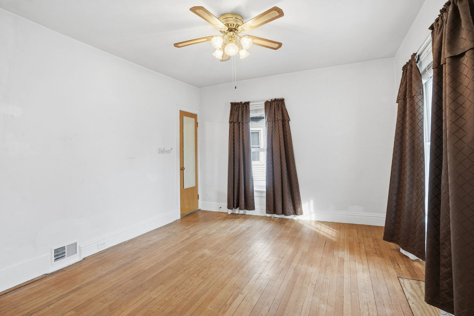 411 39th Street Moline, IL 61265 - Photo 5 of 16 a view of a hallway with a window and a ceiling fan
